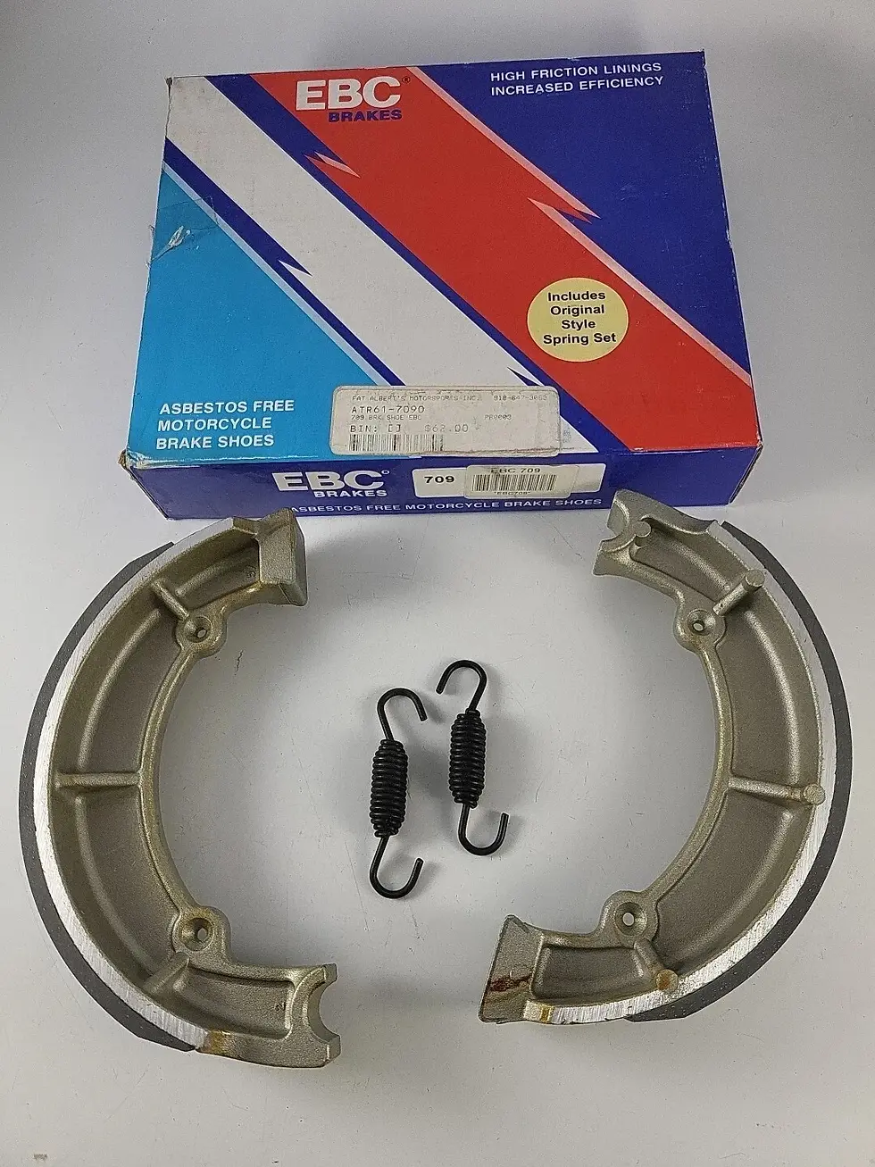 EBC 709 organic motorcycle brake shoes – pair showing friction lining and return spring assembly