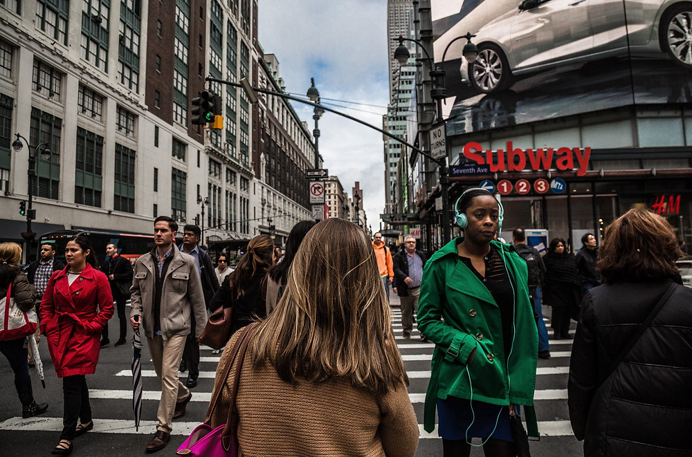 a group of people walking through New York City