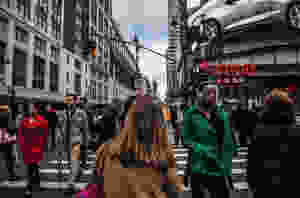 a group of people walking through New York City