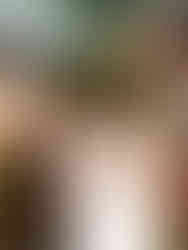 groom holding his brides hands and smiling during their Smoky Mountain elopement on a mountain outlook in the fall