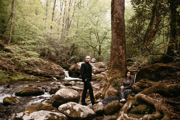 elope to gatlinburg with smoky mountain elopement photographer capturing groom posing in a dried river bed in the woods 