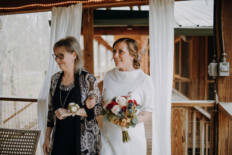 mother of the bride and the bride walking down the aisle together at a Smoky Mountain Honeymoon Cabins ceremony