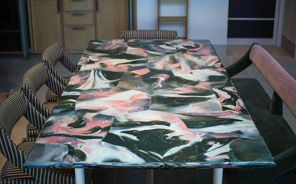 Large recycled plastic dining table with marble-effect surface in green, pink and cream, London residential project