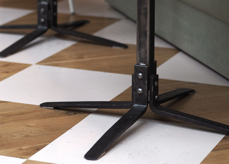 Steel table base paired with recycled plastic tabletop in hospitality interior setting