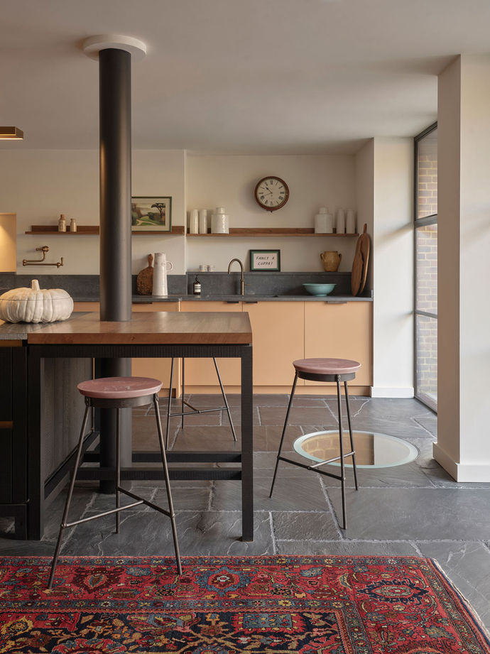 Recycled plastic stools and table set with marble-effect surfaces in open-plan interior