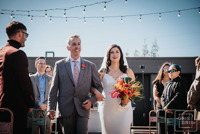 bride walks down aisle with father