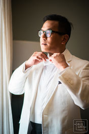 groom fixing his tie