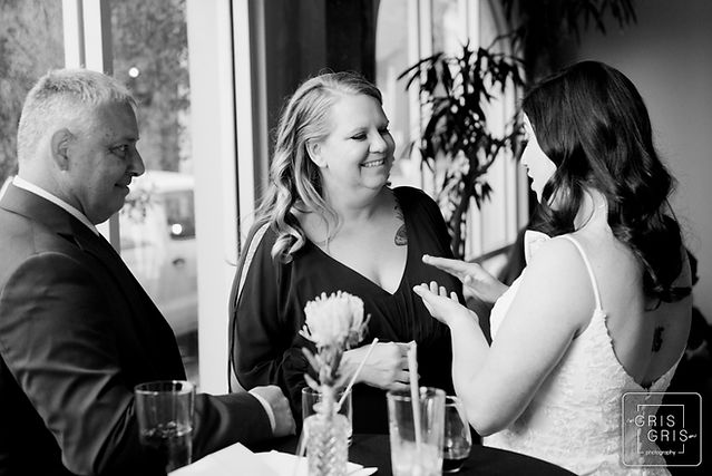 black and white photo of bride talking to guests