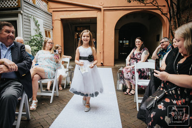 flower girl walks dow aisle at new orleans pharmacy