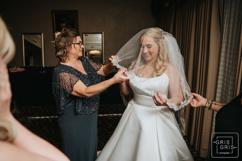 bride pitting on her veil