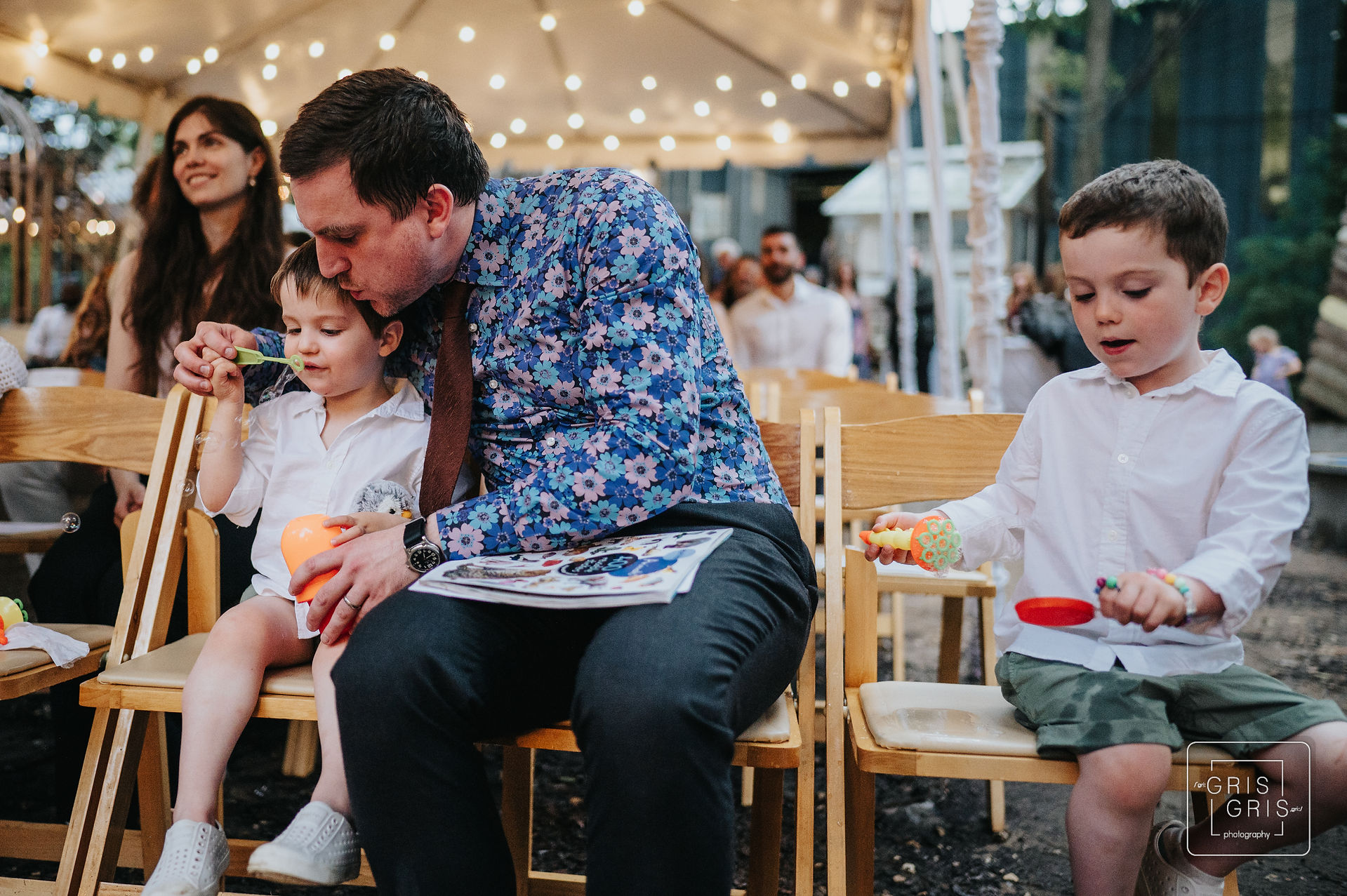 ring bearer blowing bubbles during wedding ceremony