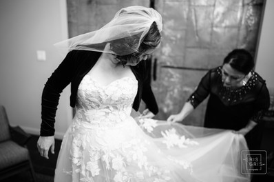 mother of bride helping bride with dress a t capulet weddings