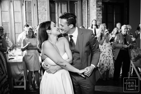 kiss durring 1st dance in black in white image