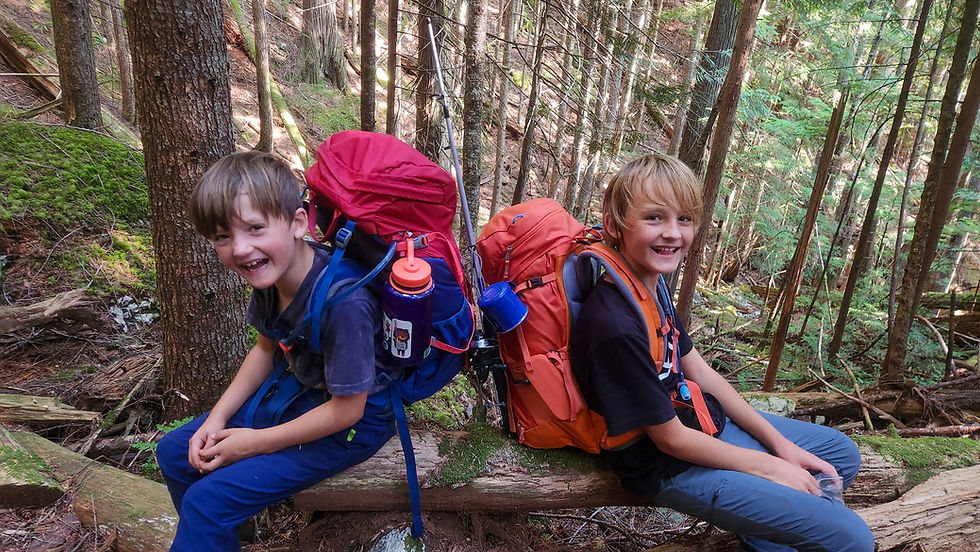 Two boys with overnight backpacks on big hike