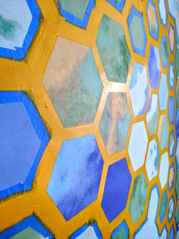 blue and green honeycomb patterning mural