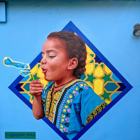 child blowing bubbles with geometric patterning