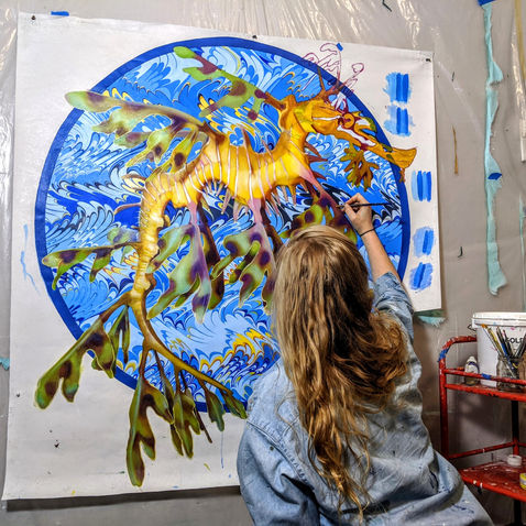muralist painting flora and fauna sea life
