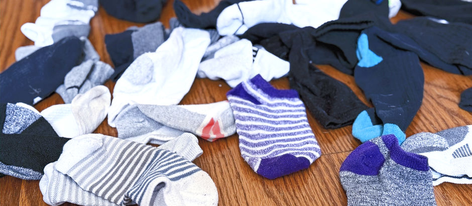 A pile of our socks missing mates, because our laundry service lost them