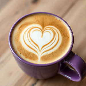 close up of perfectly made latte with heart on top, in a lovely purple mug.jpg