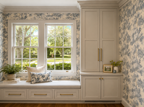 Custom playroom storage cabinetry designed around existing windows