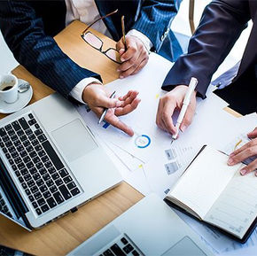 people at the table working with documents