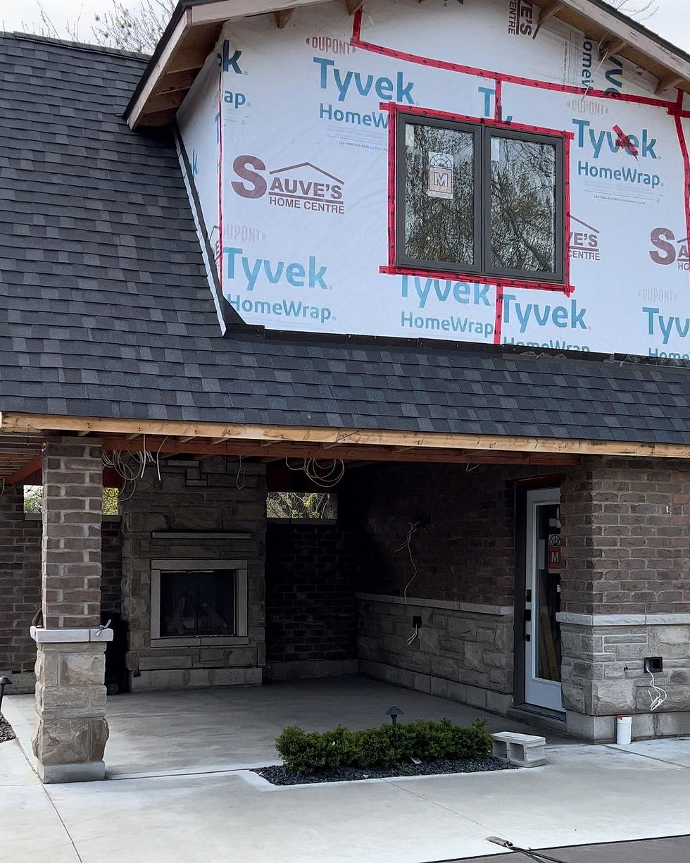 Pool house in Lakeshore with a brick pillar and brick walls on stone bases under a covered patio
