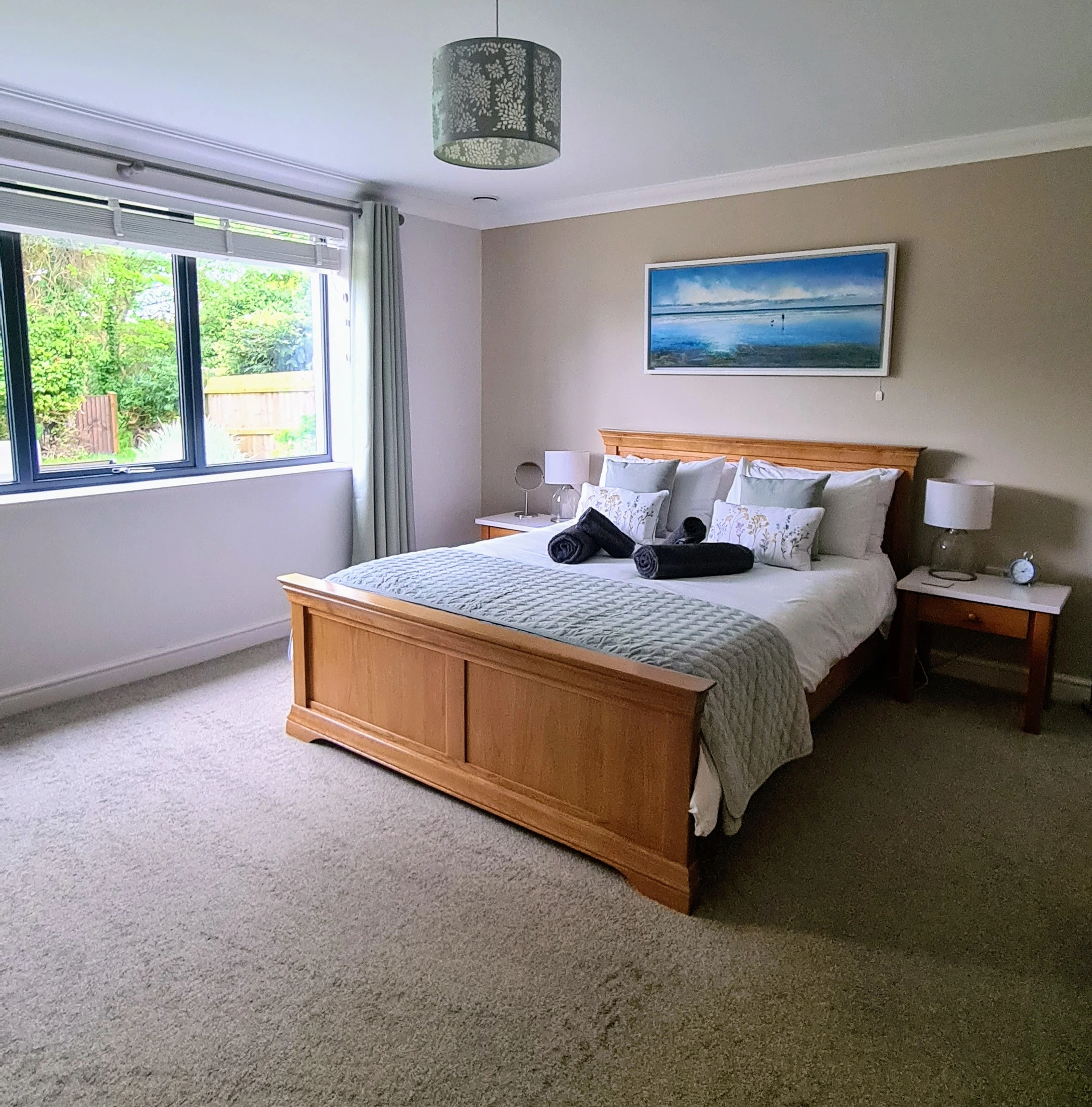 Tree Top View Sheringham bedroom with king size bed and woodland view onto the bird feeder