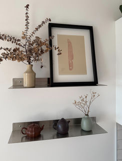 Stainless steel shelving displaying items.