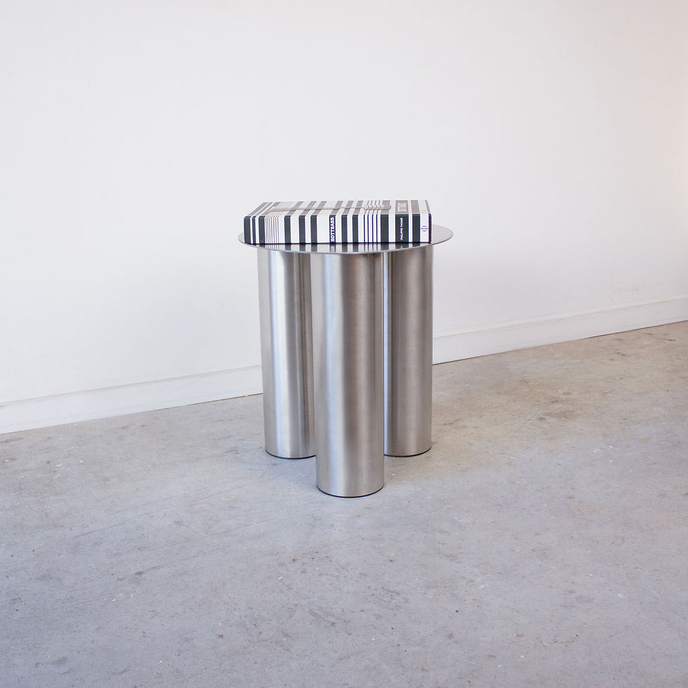 Stainless steel side table styled with a coffee table book