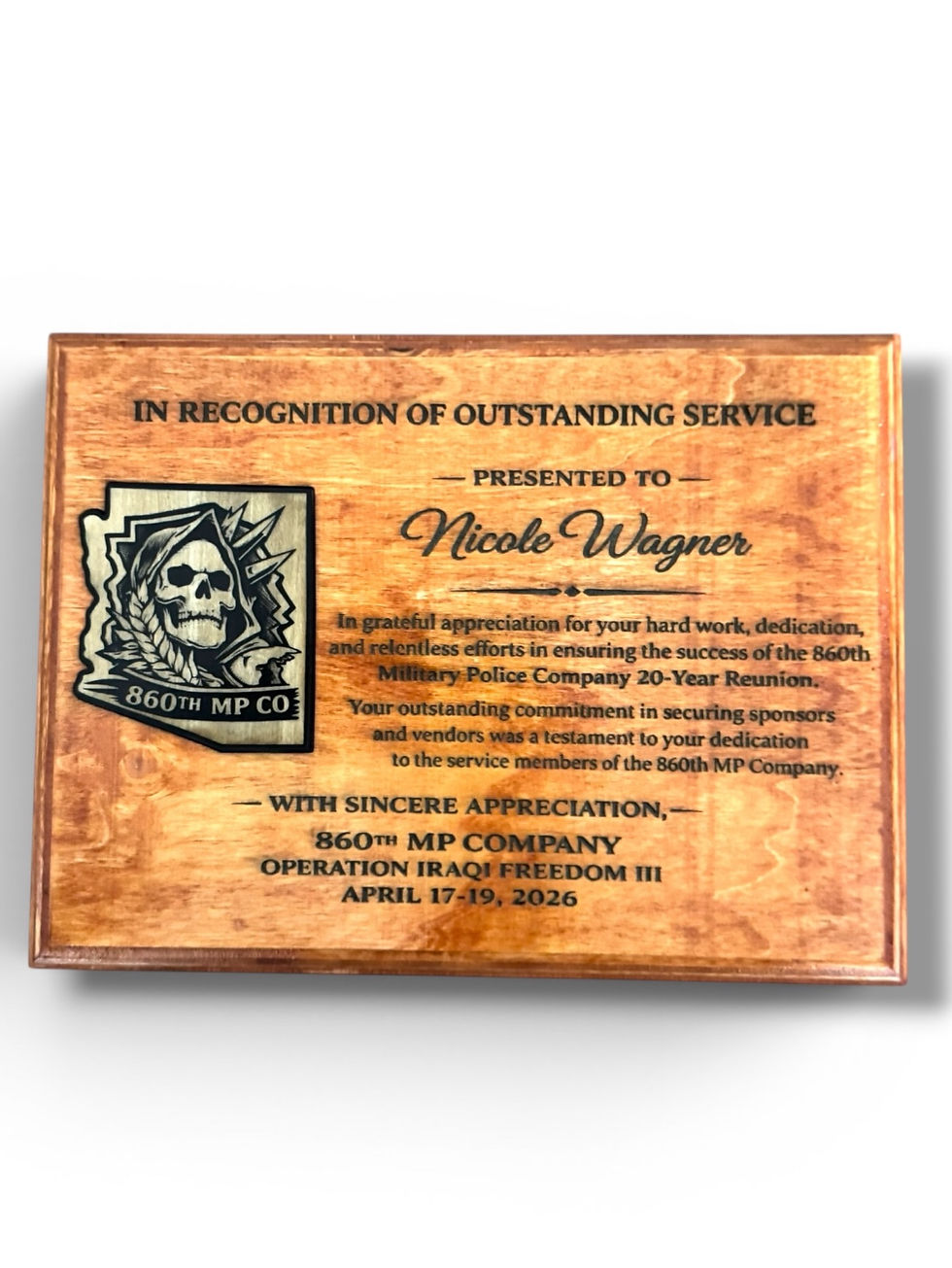 Wooden plaque with skull emblem and text honoring Nicole Wagner for service with 860th MP Co. Event: April 17-19, 2026.