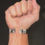 Thumbnail: Hand with silver bracelet, fist closed, Remembrance Portraits, on neutral background