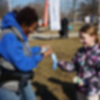 Dominique awarding a young runner on their first race