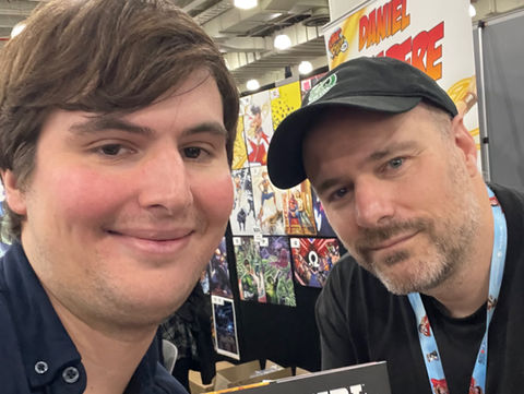Anthony Orlando holding a copy of Supergirl: Woman of Tomorrow with writer Tom King at New York Comic-Con 2024.