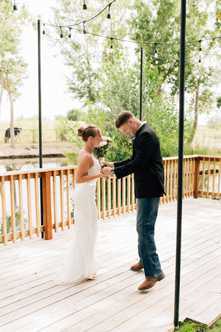 Bride and groom laughing during first look in Caldwell, Idaho