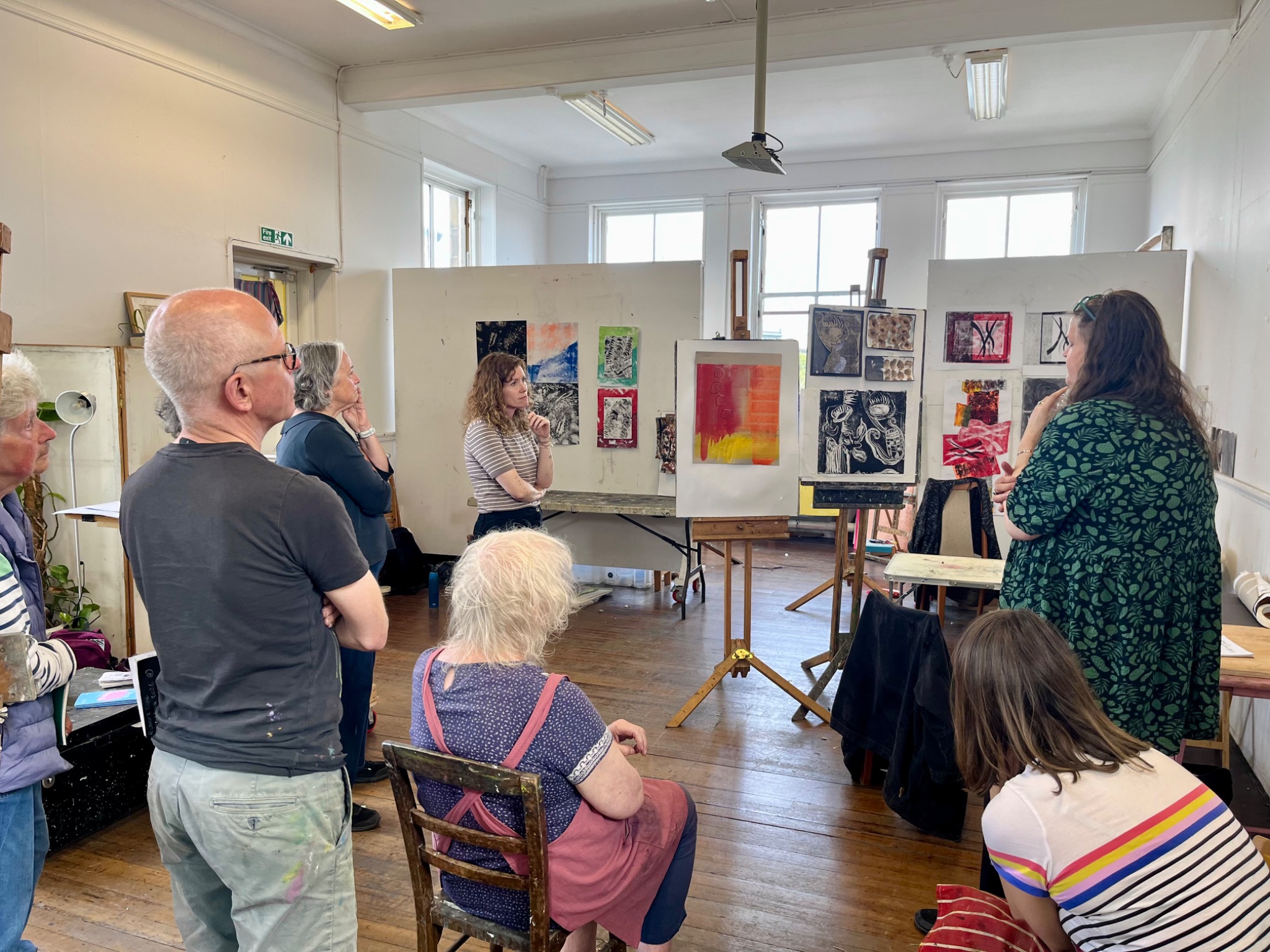 Participants discussing finished work during the final studio review