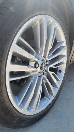 Close-up of a silver multi-spoke car alloy wheel.