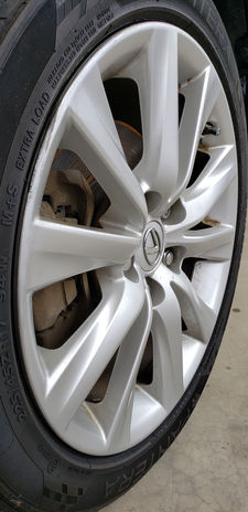 Silver multi-spoke alloy wheel with tire