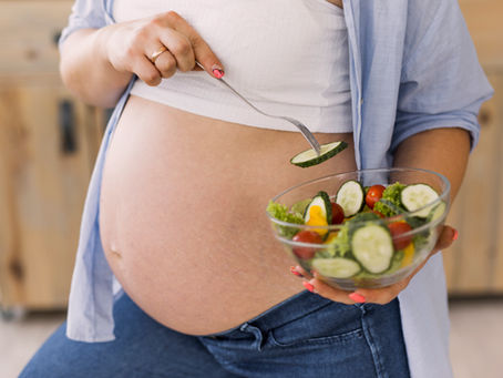 Mulher gestante comendo salada