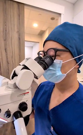 Dr Barry Yu performing root canal treatment under a dental operating microscope