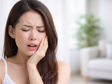 woman experiencing tooth pain after damage progresses