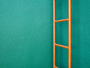 Image of a Permanent Ladder Against Green Wall