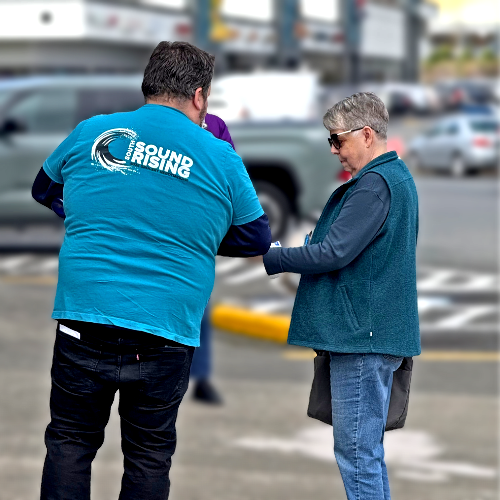 ufcw 367 member talking to a customer outside of a store about their fight for a fair contract