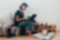 Pretty woman works from home or startup coworking space, sits barefoot on bench and writes