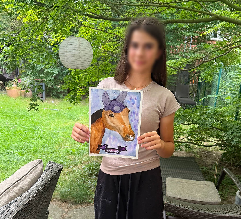 Child holding a finished artwork in the garden