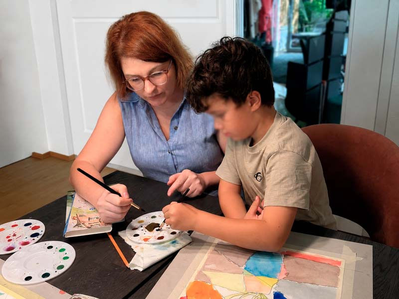 Ana Tozge helping a child during an individual art lesson