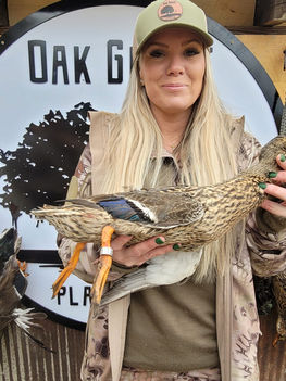 female holding dead duck
