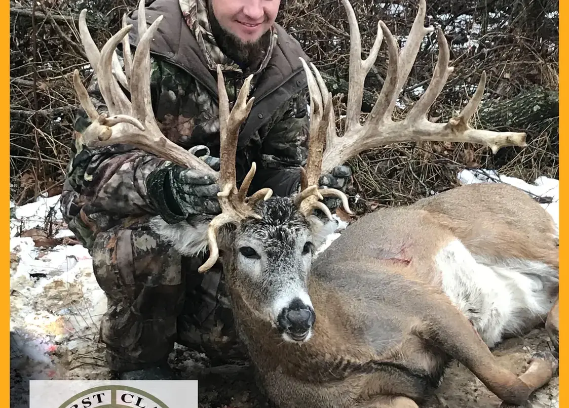 big buck with hunter holding it
