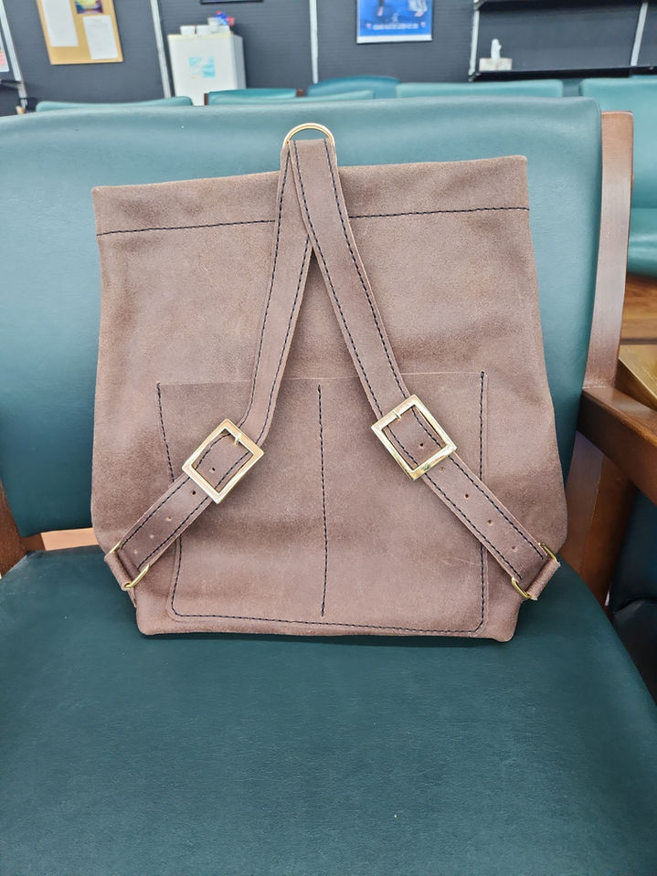 Handmade leather bag with adjustable strap and spacious interior