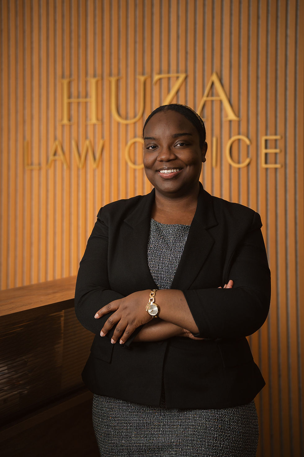 Portrait of Terry-Joe downer, lawyer in Civil Litigation and Family Law at Huza Law Office Cornwall with Huza Law Office sign in the background