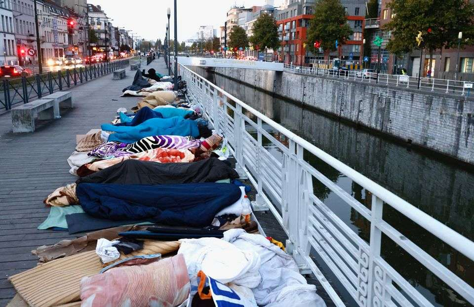 Asylum seekers sleep on a street in central Brussels, Belgium. [Image credit: Reuters/Yves Herman]